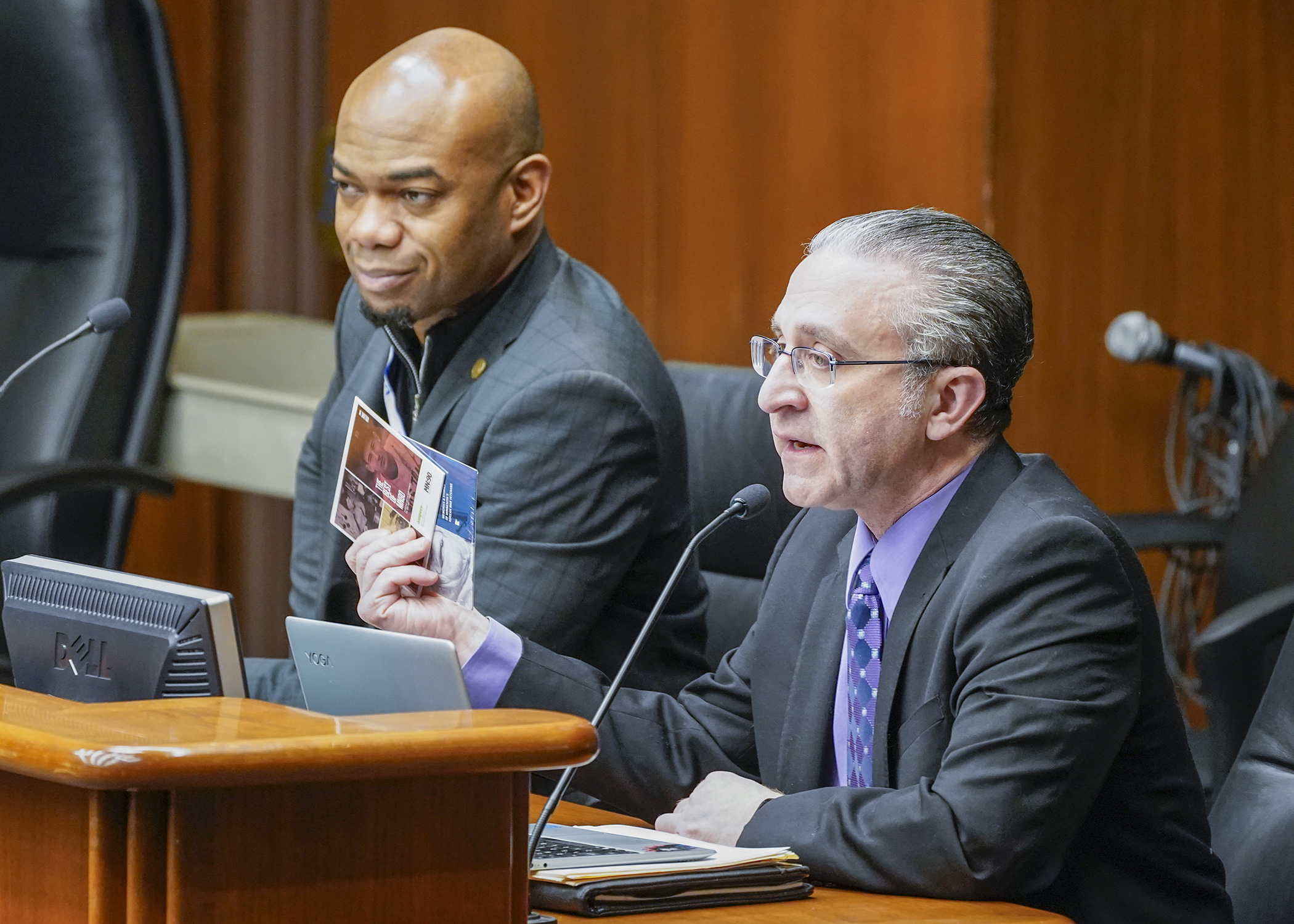Joel Glaser, president and CEO of Ampers, testifies before the House Legacy Finance Committee in support of a bill sponsored by Rep. Cedrick Frazier, left, that would provide $3.9 million in public educational radio funding. (Photo by Andrew VonBank)